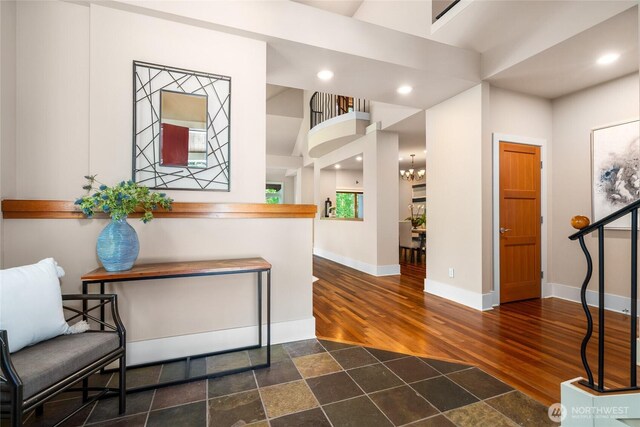13730 Main St, Bellevue, WA 98005 - hall with dark wood-type flooring, a chandelier, and recessed lighting