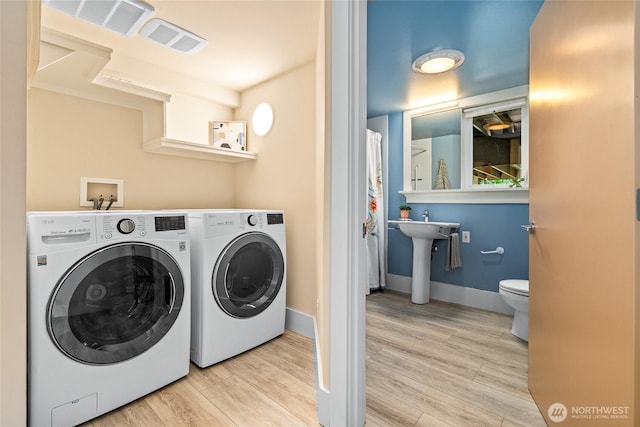 13730 Main St, Bellevue, WA 98005 - laundry area featuring washer and dryer and wood finished floors