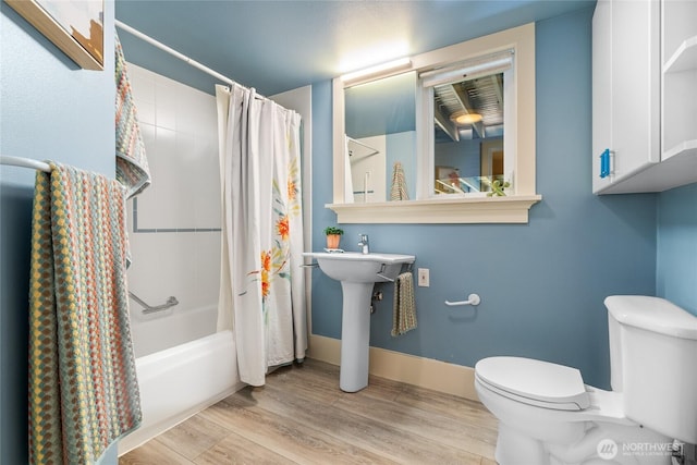 13730 Main St, Bellevue, WA 98005 - full bathroom with shower / bath combo with shower curtain and wood finished floors