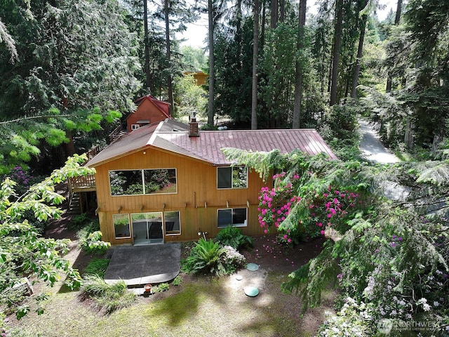 808 Woodsong Ln, Langley, WA 98260 - back of property featuring a metal roof, a chimney, and stairs