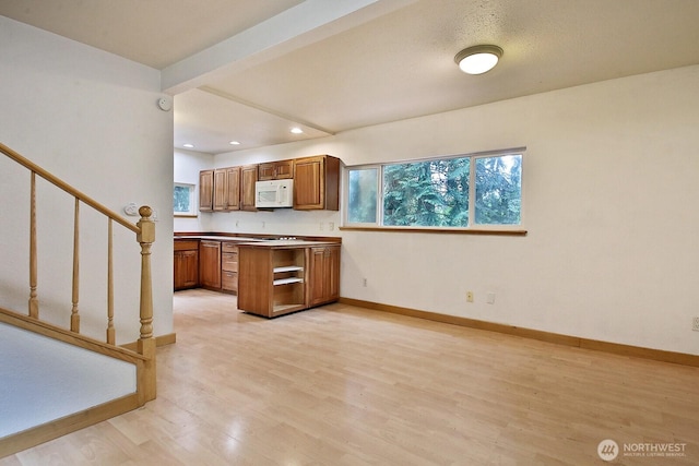 808 Woodsong Ln, Langley, WA 98260 - kitchen featuring white microwave, brown cabinetry, light wood-type flooring, and recessed lighting