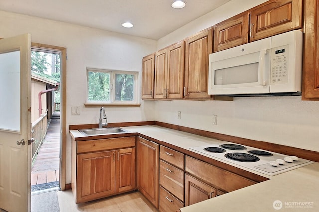 808 Woodsong Ln, Langley, WA 98260 - kitchen featuring white appliances, brown cabinetry, recessed lighting, light countertops, and light wood-style flooring