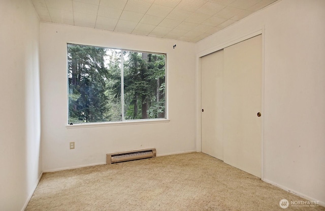 808 Woodsong Ln, Langley, WA 98260 - unfurnished bedroom featuring a baseboard radiator, multiple windows, and carpet
