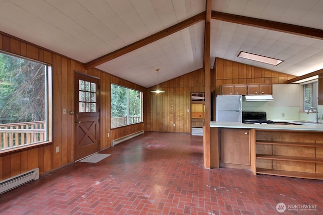 808 Woodsong Ln, Langley, WA 98260 - kitchen featuring freestanding refrigerator, a baseboard radiator, ventilation hood, wood walls, and brown cabinets