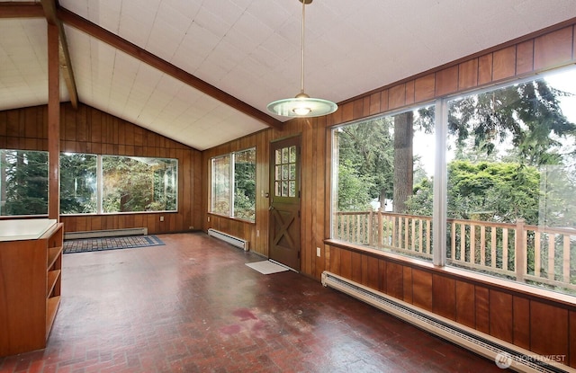 808 Woodsong Ln, Langley, WA 98260 - unfurnished sunroom featuring a baseboard heating unit, wood walls, and brick patterned floors