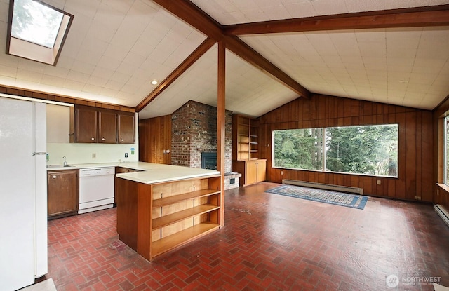808 Woodsong Ln, Langley, WA 98260 - kitchen featuring white appliances, a baseboard heating unit, wooden walls, a fireplace, and light countertops