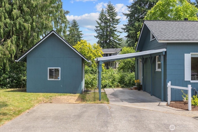 1115Avenue A, Snohomish, WA 98290 - view of home's exterior with roof with shingles, an attached carport, asphalt driveway, and a yard