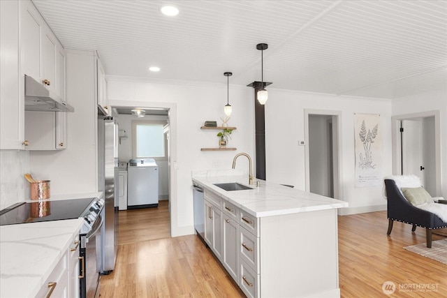 1115Avenue A, Snohomish, WA 98290 - kitchen featuring stainless steel appliances, under cabinet range hood, light wood finished floors, ornamental molding, and washer and clothes dryer