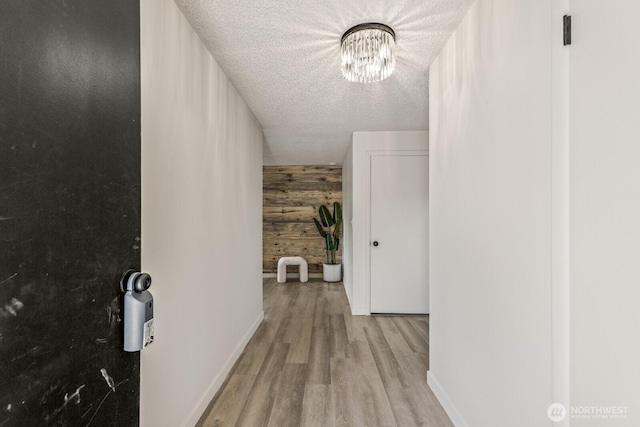 15330 40th Ave W Unit A & B, Lynnwood, WA 98087 - corridor featuring wooden walls, a textured ceiling, wood finished floors, a chandelier, and baseboards