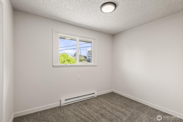 15330 40th Ave W Unit A & B, Lynnwood, WA 98087 - empty room featuring a baseboard heating unit, dark colored carpet, baseboards, and a textured ceiling