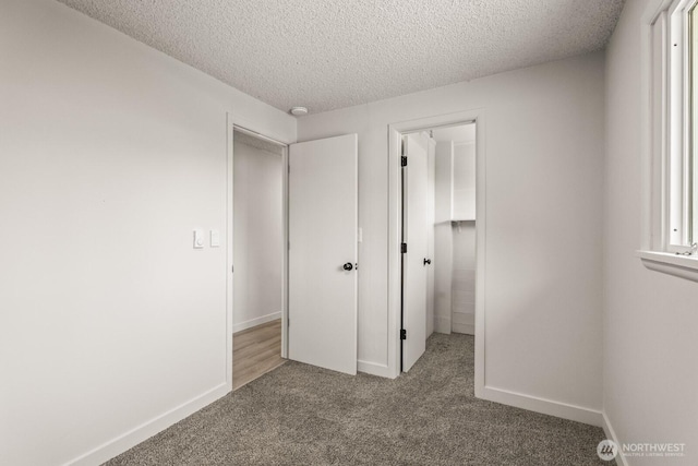 15330 40th Ave W Unit A & B, Lynnwood, WA 98087 - unfurnished bedroom with carpet flooring, a textured ceiling, baseboards, and a closet