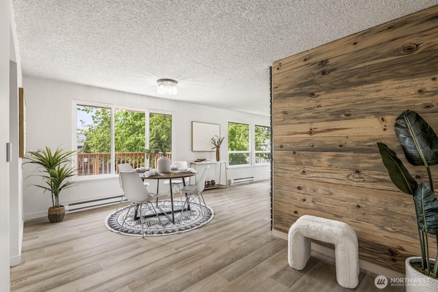 15330 40th Ave W Unit A & B, Lynnwood, WA 98087 - dining room featuring a baseboard heating unit, baseboard heating, wood finished floors, and a textured ceiling