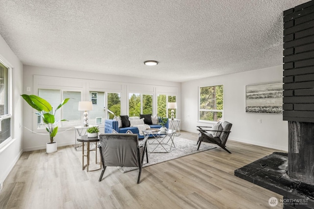 15330 40th Ave W Unit A & B, Lynnwood, WA 98087 - living room featuring wood finished floors, baseboards, and a textured ceiling