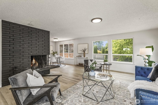 15330 40th Ave W Unit A & B, Lynnwood, WA 98087 - living area with a textured ceiling, wood finished floors, a fireplace, and baseboards