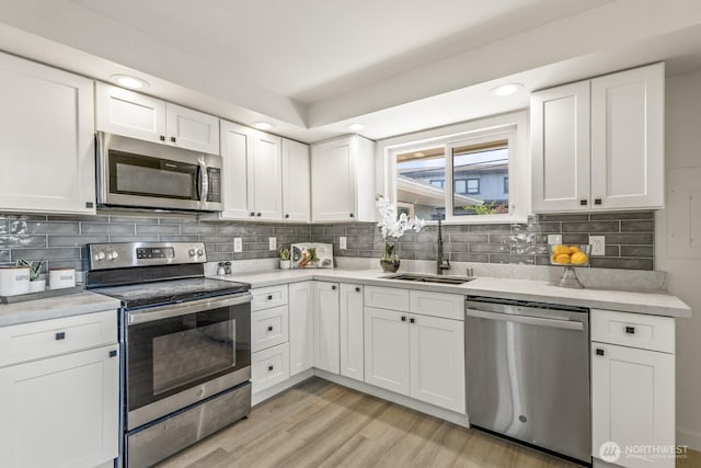 15330 40th Ave W Unit A & B, Lynnwood, WA 98087 - kitchen featuring appliances with stainless steel finishes, a sink, light countertops, white cabinets, and recessed lighting