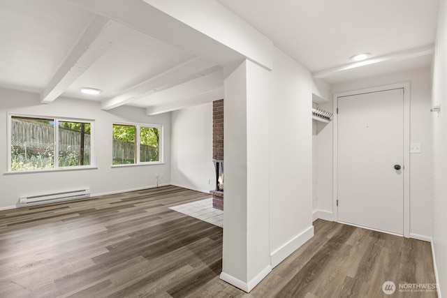 15330 40th Ave W Unit A & B, Lynnwood, WA 98087 - unfurnished room with baseboard heating, wood finished floors, beamed ceiling, a brick fireplace, and baseboards
