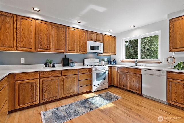 29247 188th Ave SE, Kent, WA 98042 - kitchen with white appliances, brown cabinets, light countertops, light wood-style flooring, and recessed lighting