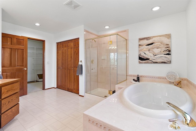 29247 188th Ave SE, Kent, WA 98042 - full bath with a stall shower, a bath, recessed lighting, a walk in closet, and tile patterned flooring