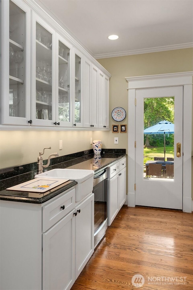 19840 Vashon Hwy SW, Vashon, WA 98070 - kitchen with crown molding, white cabinets, wine cooler, glass insert cabinets, and dark countertops