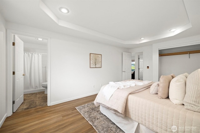 312 W 2nd St # 3, Nooksack, WA 98276 - bedroom with a raised ceiling, wood finished floors, recessed lighting, connected bathroom, and a closet