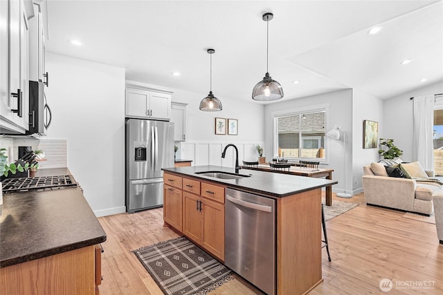 2183 Lagerwey Cir, Lynden, WA 98264 - kitchen featuring appliances with stainless steel finishes, dark countertops, plenty of natural light, a kitchen breakfast bar, and recessed lighting