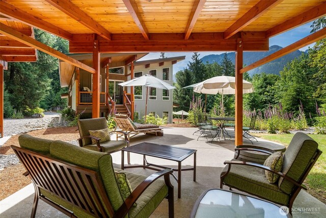 20720 501st Dr SE, Index, WA 98251 - view of patio with an outdoor living space, outdoor dining space, and a mountain view