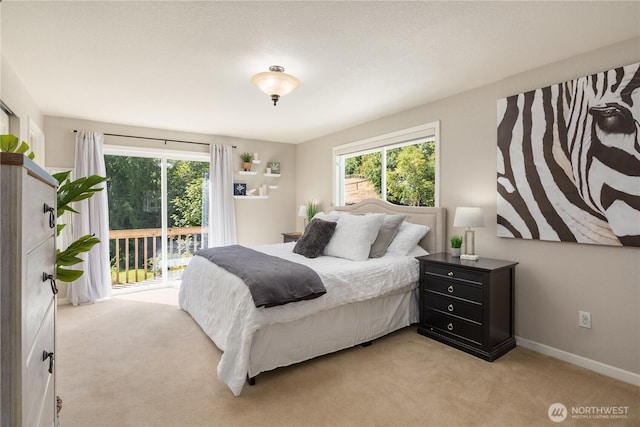 1204 SE Oak Rd, Port Orchard, WA 98367 - bedroom featuring access to exterior, light colored carpet, and baseboards