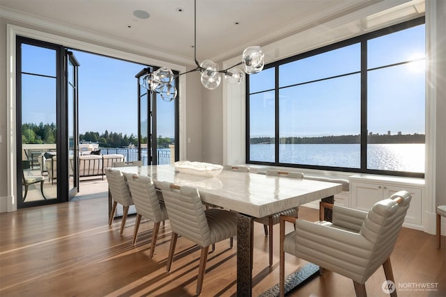 1615 Roanoke Way, Mercer Island, WA 98040 - dining area with a chandelier, healthy amount of natural light, wood finished floors, ornamental molding, and a water view