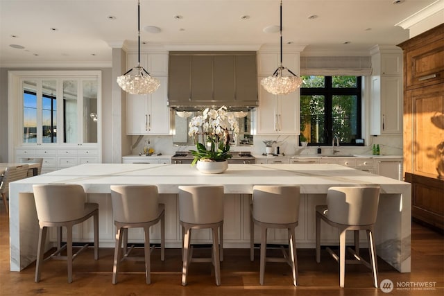 1615 Roanoke Way, Mercer Island, WA 98040 - kitchen with a chandelier, ornamental molding, wall chimney range hood, backsplash, and white cabinetry