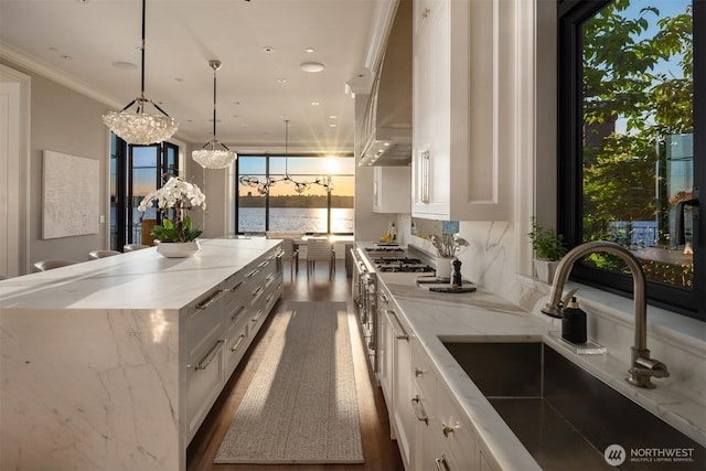 1615 Roanoke Way, Mercer Island, WA 98040 - kitchen featuring a sink, wall chimney exhaust hood, white cabinets, wood finished floors, and a center island