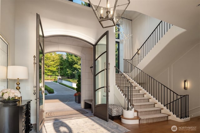 1615 Roanoke Way, Mercer Island, WA 98040 - foyer entrance featuring a high ceiling, a chandelier, plenty of natural light, stairway, and baseboards