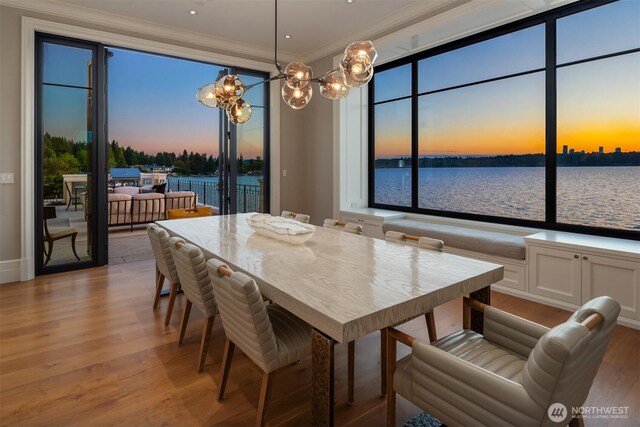 1615 Roanoke Way, Mercer Island, WA 98040 - dining room featuring a chandelier, crown molding, wood finished floors, and a water view