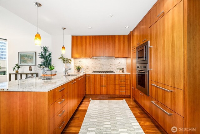 10700 NE 4th St Unit 806, Bellevue, WA 98004 - kitchen with stainless steel appliances, modern cabinets, a peninsula, dark wood-type flooring, and recessed lighting