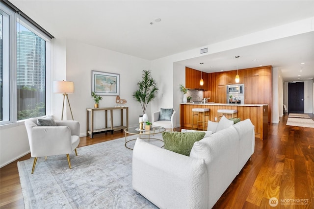 10700 NE 4th St Unit 806, Bellevue, WA 98004 - living area with healthy amount of natural light and dark wood-style flooring