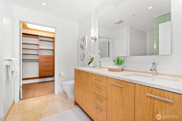 10700 NE 4th St Unit 806, Bellevue, WA 98004 - full bathroom with double vanity, a walk in closet, and recessed lighting