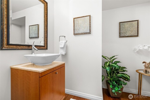 10700 NE 4th St Unit 806, Bellevue, WA 98004 - bathroom featuring vanity and wood finished floors
