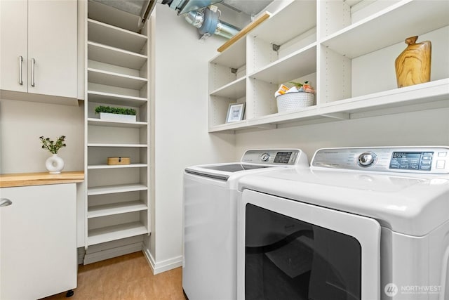 10700 NE 4th St Unit 806, Bellevue, WA 98004 - washroom with washing machine and dryer and light wood-type flooring