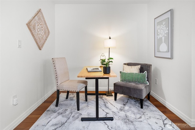 10700 NE 4th St Unit 806, Bellevue, WA 98004 - living area featuring baseboards and wood finished floors