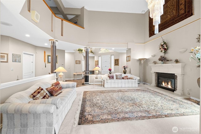 10316 NE 153rd Pl, Bothell, WA 98011 - living room with a towering ceiling, a glass covered fireplace, baseboards, a chandelier, and recessed lighting