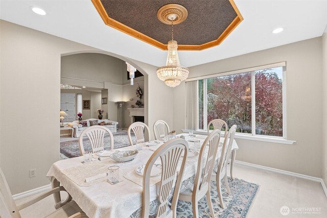 10316 NE 153rd Pl, Bothell, WA 98011 - carpeted dining room with a raised ceiling, a chandelier, baseboards, arched walkways, and recessed lighting
