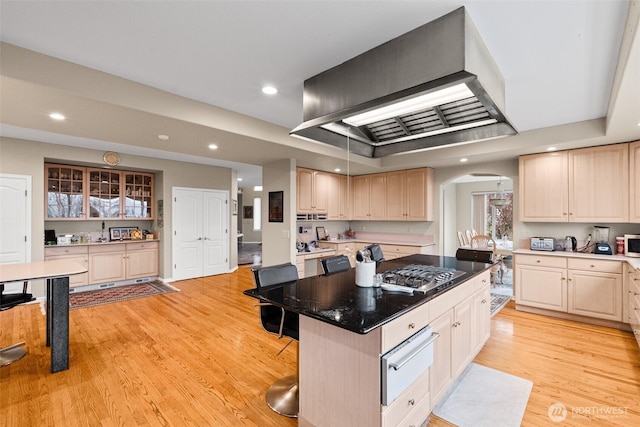 10316 NE 153rd Pl, Bothell, WA 98011 - kitchen with a warming drawer, arched walkways, premium range hood, stainless steel gas stovetop, and a kitchen island