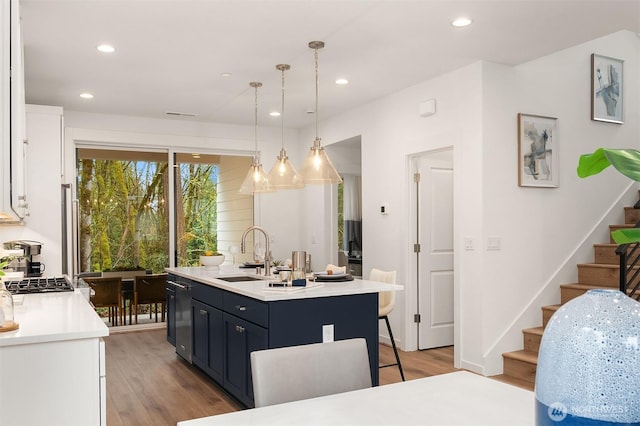 13434 HS3 NE 112th Pl, Redmond, WA 98052 - kitchen featuring a sink, light countertops, white cabinetry, a kitchen breakfast bar, and an island with sink