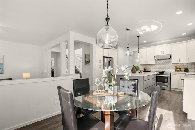 7645 Dogwood Ln SE, Snoqualmie, WA 98065 - dining room featuring dark wood-style flooring, recessed lighting, and stairway