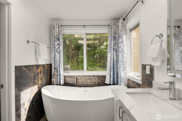 7645 Dogwood Ln SE, Snoqualmie, WA 98065 - full bathroom with tile walls, a freestanding tub, vanity, and wainscoting