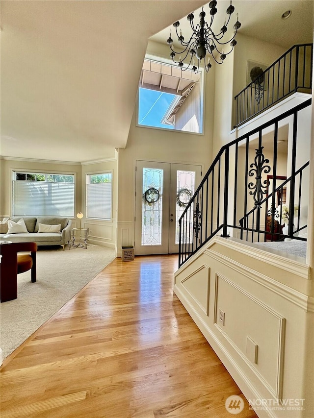 8228 NE 187th Way, Kenmore, WA 98028 - entrance foyer featuring a chandelier, wood finished floors, healthy amount of natural light, stairway, and a high ceiling