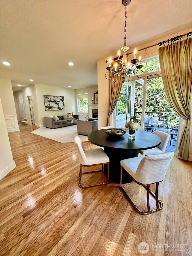 8228 NE 187th Way, Kenmore, WA 98028 - dining room with a chandelier, light wood-type flooring, recessed lighting, and a fireplace