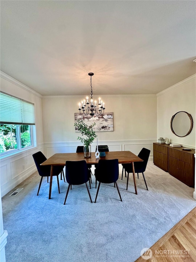 8228 NE 187th Way, Kenmore, WA 98028 - dining space with a chandelier, light colored carpet, crown molding, and a wainscoted wall