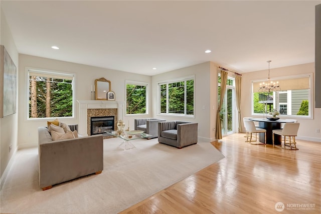 8228 NE 187th Way, Kenmore, WA 98028 - living area featuring a chandelier, radiator, light wood-style flooring, a glass covered fireplace, and recessed lighting