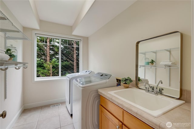 8228 NE 187th Way, Kenmore, WA 98028 - laundry area featuring washing machine and clothes dryer, cabinet space, and light tile patterned flooring
