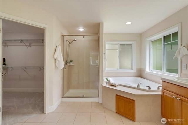 8228 NE 187th Way, Kenmore, WA 98028 - bathroom featuring a stall shower, a garden tub, vanity, a spacious closet, and tile patterned flooring